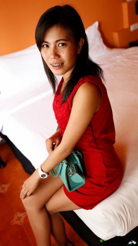 Sexy Asian Wan shows off her petite body while undressing for sex