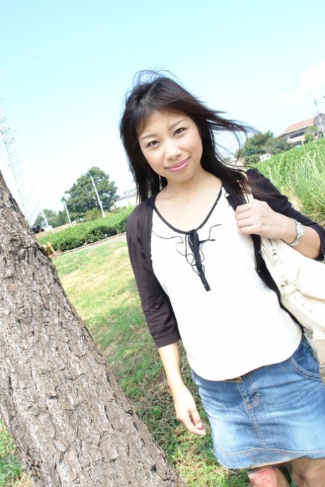 Japanese babe Karin Asahi reveals her big tits and hot pussy outdoors