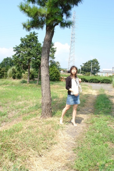 Japanese babe Karin Asahi reveals her big tits and hot pussy outdoors