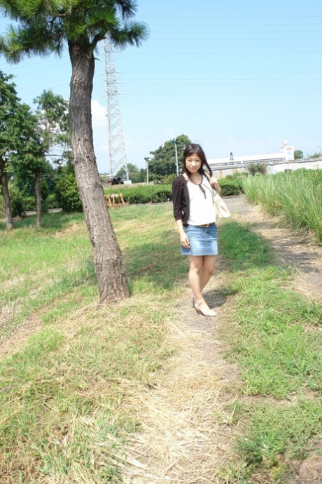 Japanese babe Karin Asahi reveals her big tits and hot pussy outdoors